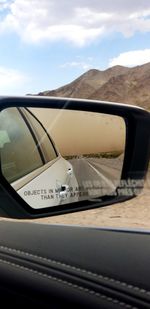 Reflection of sky on side-view mirror