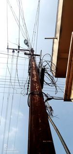 Low angle view of electricity pylon against sky