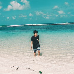 Full length of man on beach against sky