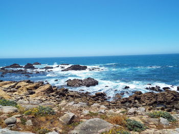 Scenic view of sea against clear blue sky