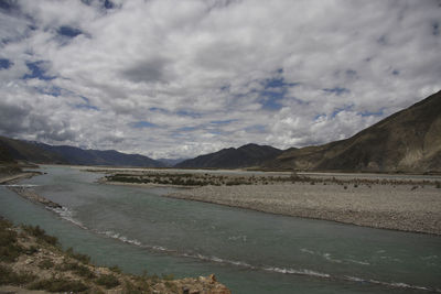 Scenic view of lake and mountains against sky