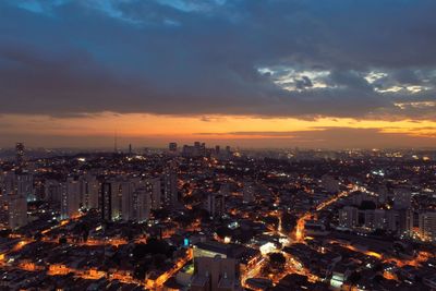 High angle view of illuminated buildings against sky at night