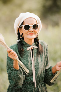 Portrait of man wearing sunglasses standing outdoors