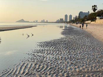 Scenic view of beach against sky during sunset