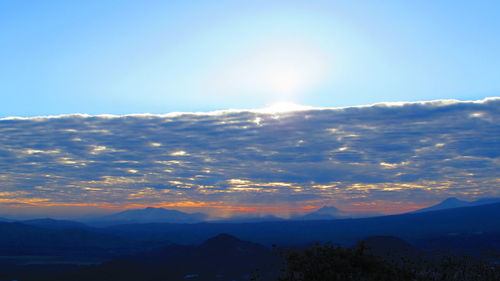 Scenic view of mountains against sky at sunset