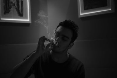 Man smoking cigarette at home