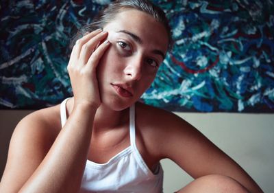 Portrait of beautiful young woman sitting at home