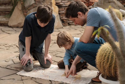 Three travellers trying to find treasures in desert