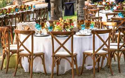 Place setting on table amidst chairs at outdoor restaurant