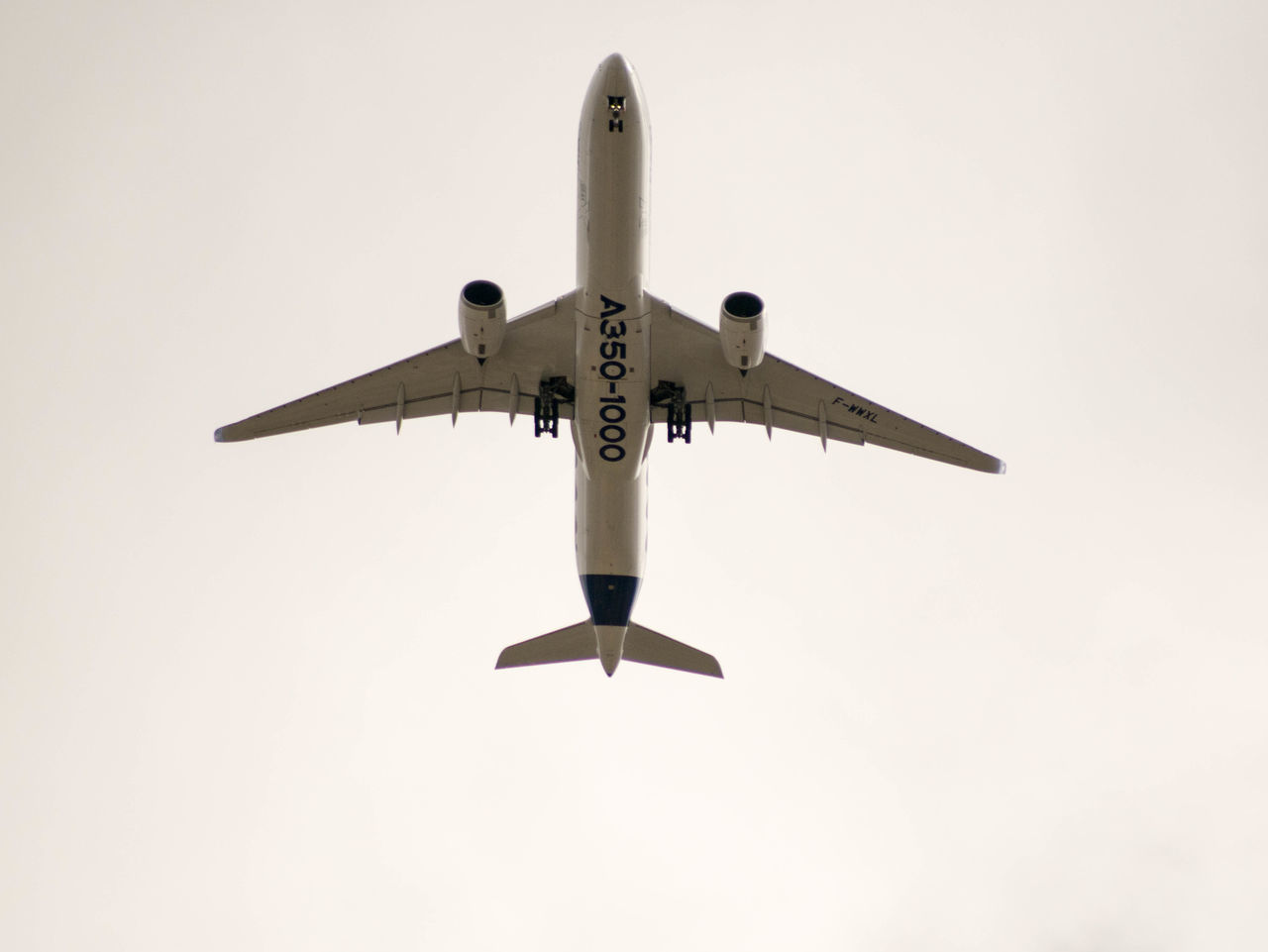 LOW ANGLE VIEW OF AIRPLANE AGAINST CLEAR SKY