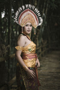 Woman looking away while standing outdoors