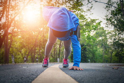 Rear view of man walking on road