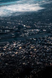 Aerial view of illuminated city by buildings at night