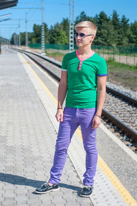 Full length of man standing on railroad station platform
