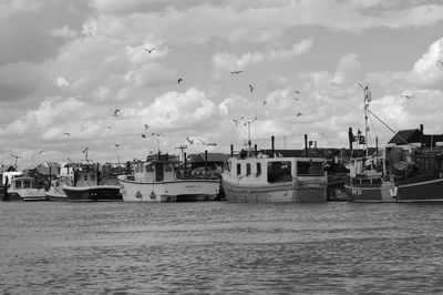 View of harbor against cloudy sky