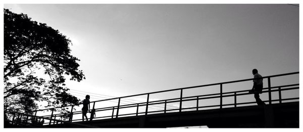 Silhouette of people against clear sky