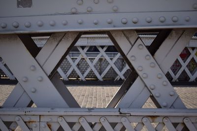 Low angle view of bridge by building against sky
