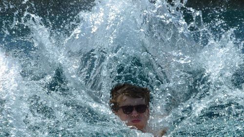 Young man swimming in sea