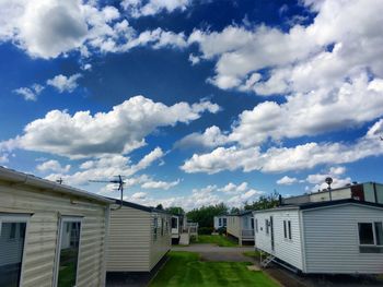 Built structures against blue sky and clouds