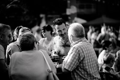 Group of people sitting on table in city