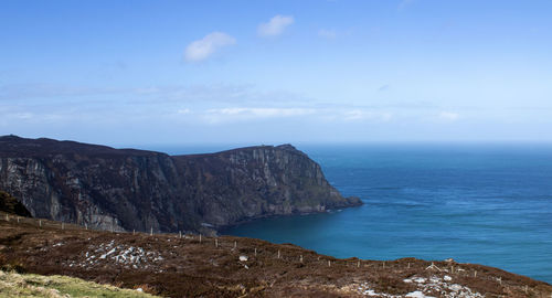 Scenic view of sea and rocks against sky