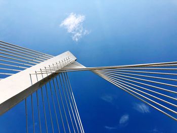 Low angle view of suspension bridge against sky