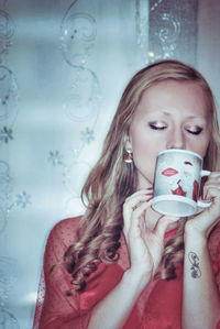 Portrait of a beautiful young woman drinking water