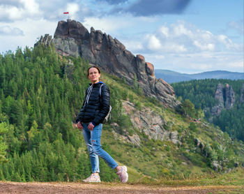 Full length of woman standing on land against sky