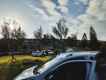 Cars on road against sky in city