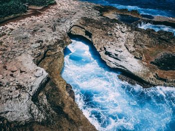 High angle view of rock formation in sea