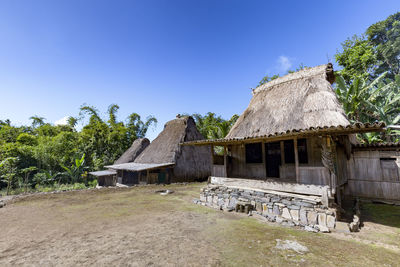 Houses by trees against clear sky