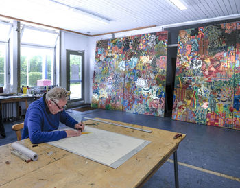 Artist drawing in his studio