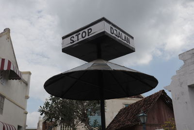 Low angle view of sign against sky