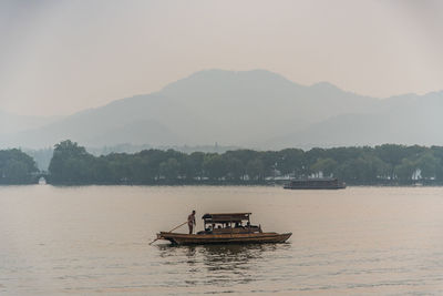 Boat in river against clear sky