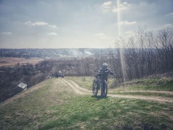 Man standing on field against sky