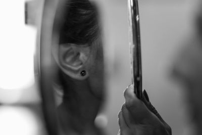 Portrait of woman with hand on mirror