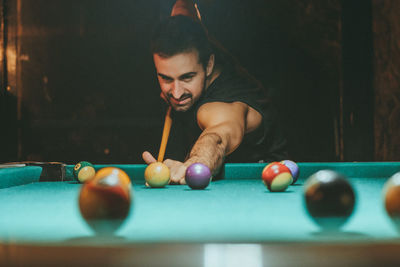 Man playing with ball on table