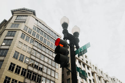 Low angle view of street light against building