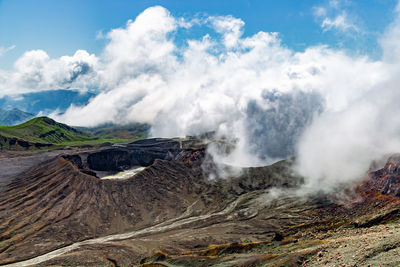 Scenic view on volcanic landscape, clouds in aso crater, aso town in kyushu, japan