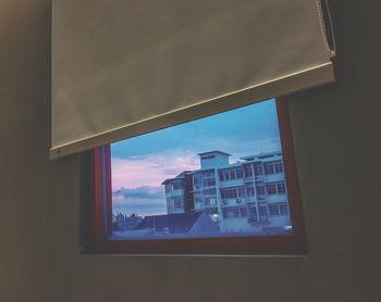 Low angle view of building seen through window