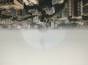 Midsection of man with city in water