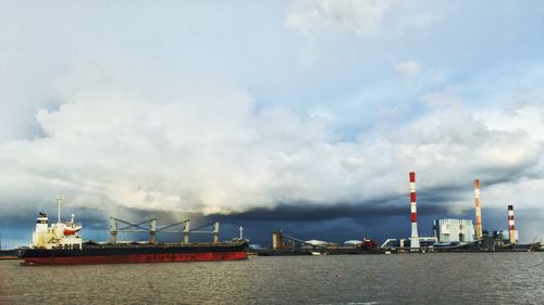 View of harbor against cloudy sky