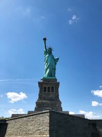 Low angle view of statue of liberty against sky