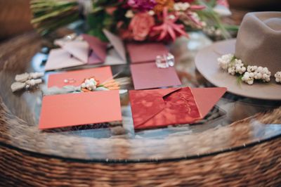 High angle view of bouquet with greeting cards and hat on table