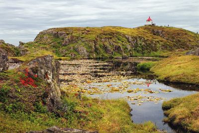 Scenic view of waterfall against sky