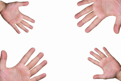 Low section of person touching hands over white background