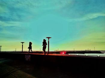 Silhouette of woman against cloudy sky