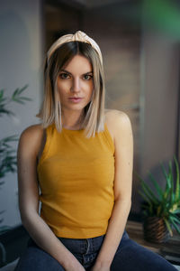 Portrait of beautiful young woman sitting outdoors