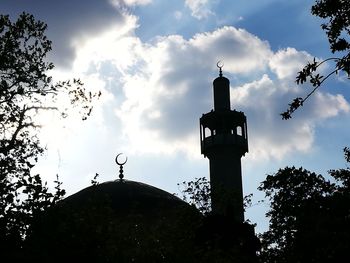 Low angle view of silhouette built structure against sky