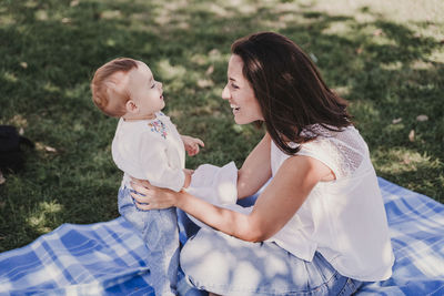 Rear view of mother and daughter outdoors